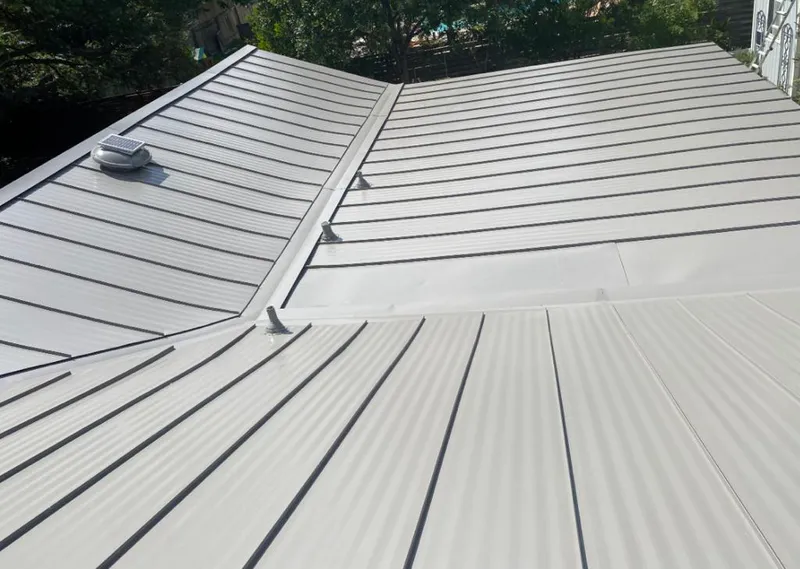 Solar attic fan installed on a metal roof for Roof Ventilation in Summit View